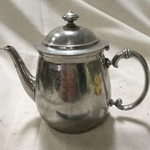Polished Silver Teapot with Decorative Handle
