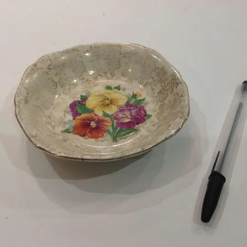 shallow ceramic dish with floral design and gold trim