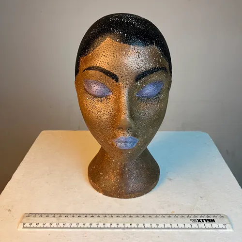 Polystyrene female bust with black hair and purple makeup