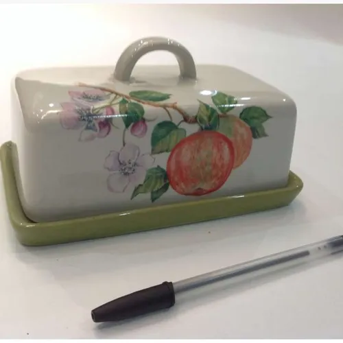 ceramic butter dish with floral and fruit design and green base