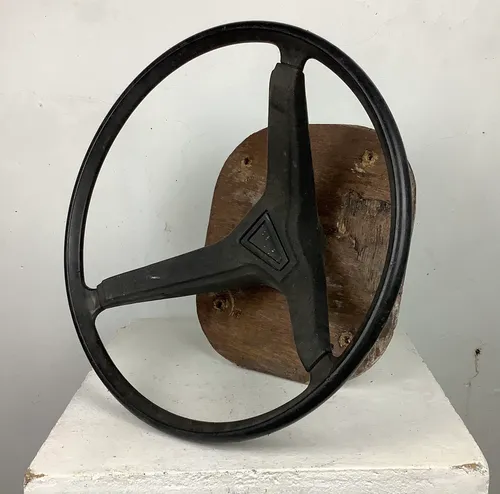 Black Steering Wheel Mounted on Wooden Board