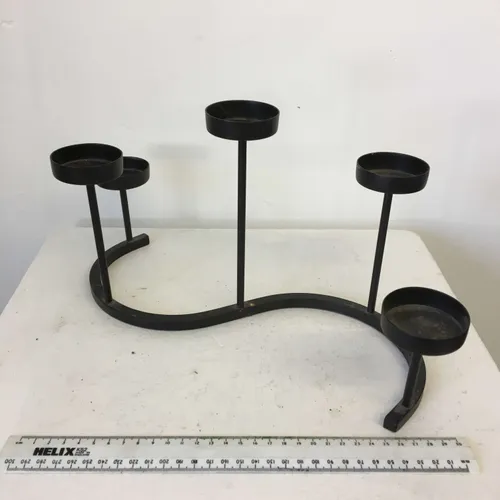 Wrought iron tea light candle holder in 'S' shape
