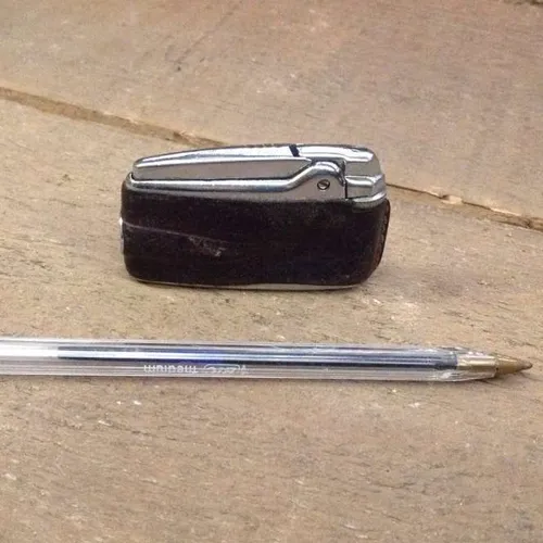 silver lighter with brown leather cover