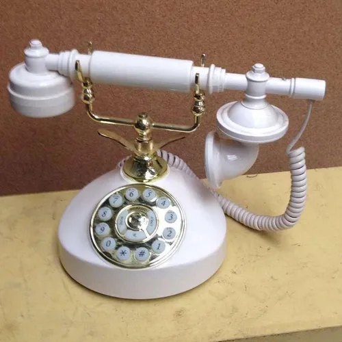 white and gold replica cradle-style corded push button telephone