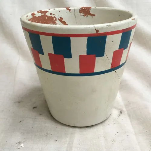Painted white plant pot with red and blue square pattern 