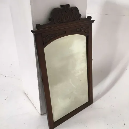 Ornate carved dark wood mirror 