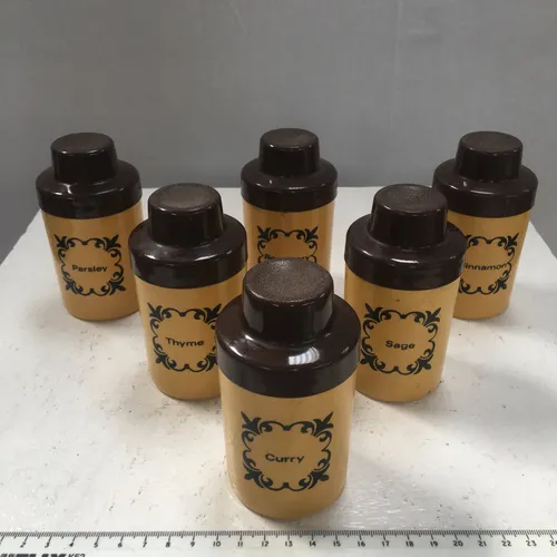 Plastic spice container set with yellow jars and brown lids