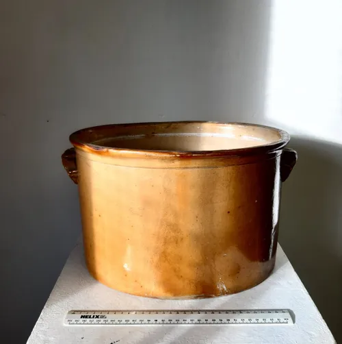 Large tan oval stoneware pot with handles
