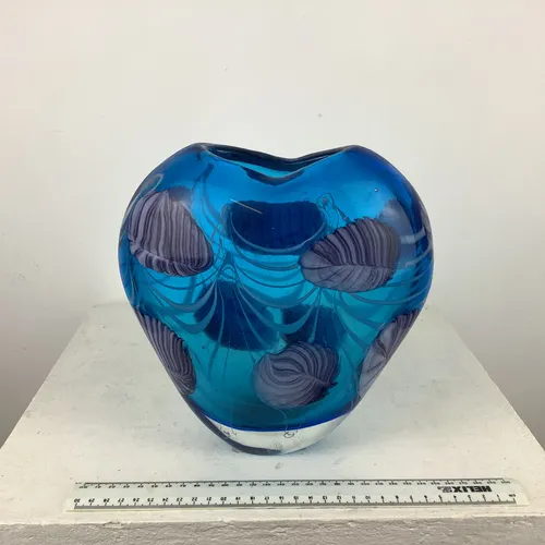 Blue glass heart shaped vase with heavy base and paler blue leaves decoration