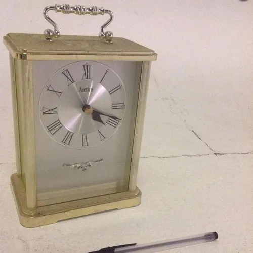 Acctim Darcey style analogue gold coloured mantle clock with silver face and glass face cover