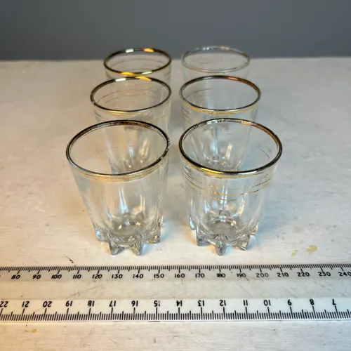 Set of six mid-century shot glasses with gold bands