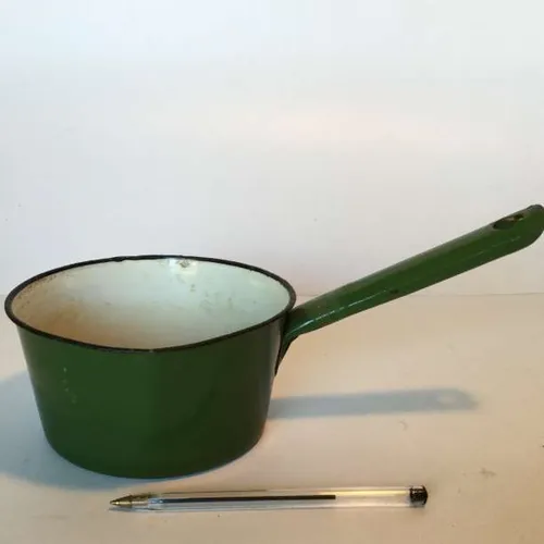 period green enamelware saucepan with white interior and black rim