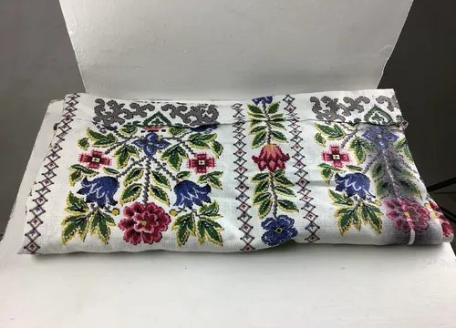 Green and red embroidered floral fabric 