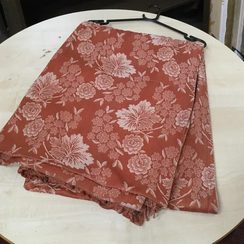 Orange drape/curtain with white flower design 