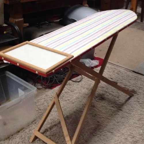 Period ironing board , wooden with fabric cover