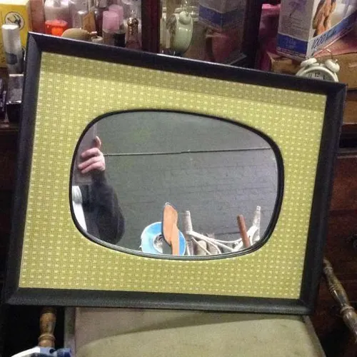 1960s mirror with padded fabric framing