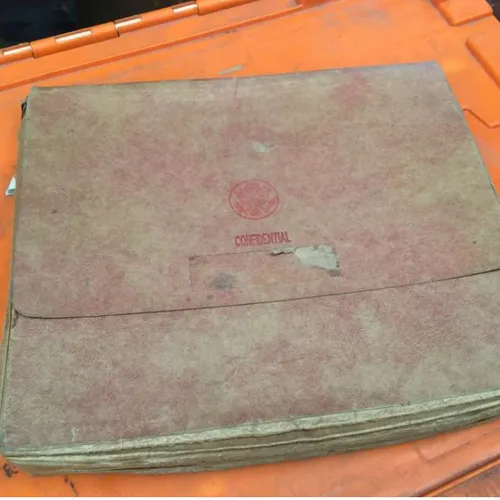 well-worn accordion file with 'confidential' stamp