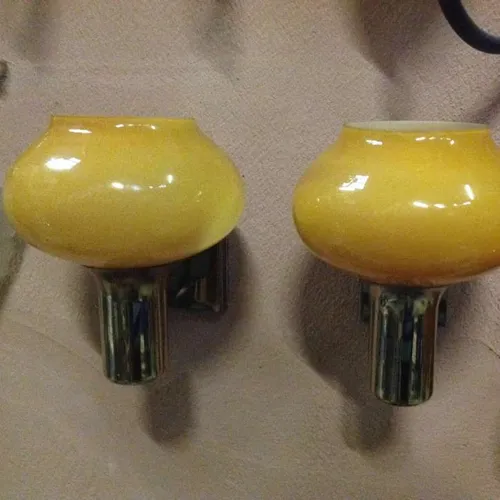 brass wall light with orange glass shade