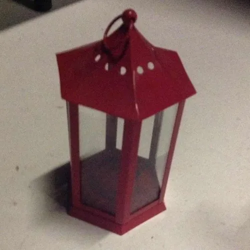 Small sized metal lantern with glass windows for realigns candles or similar