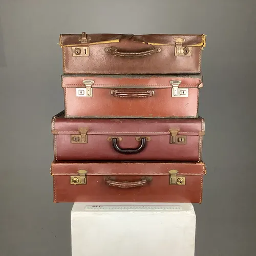 Various dark brown vintage leather suitcases