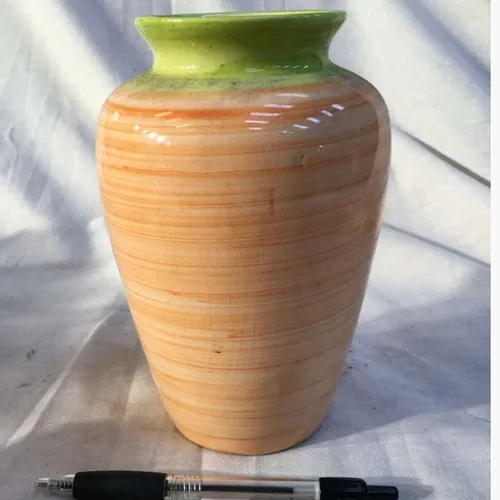 Orange ceramic vase with green top