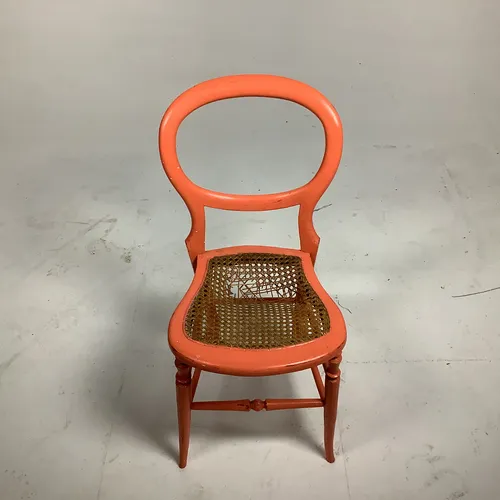 Orange painted wood round back dining chair