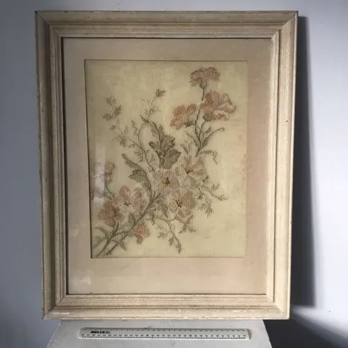 Framed cross stitch art of flowers and leaves