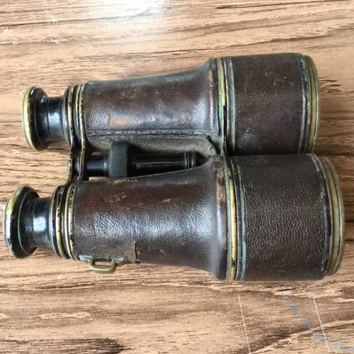 binoculars with well-worn brown leather covering and black eyepieces