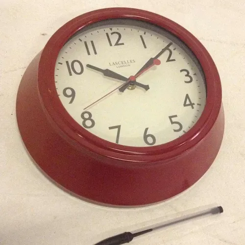 Lascelles analogue red metal wall clock with cream face and glass face cover