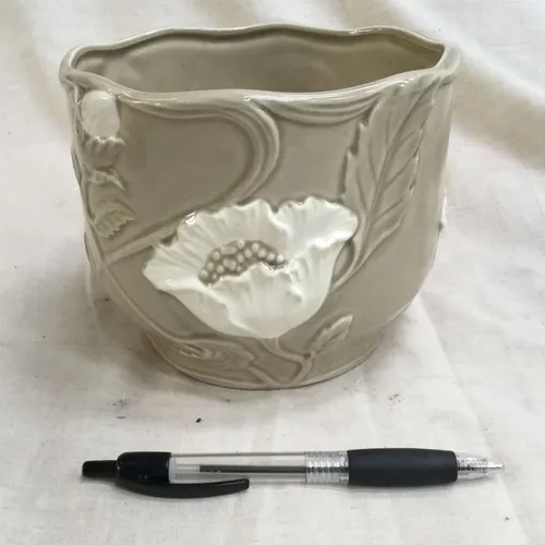 Pale grey planter with embossed white flower detail