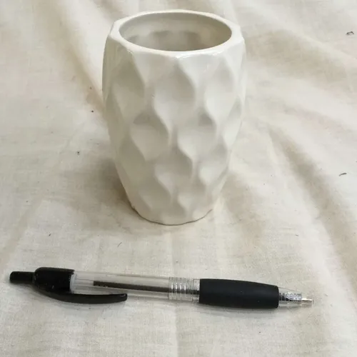 White ceramic vase with embossed pattern 