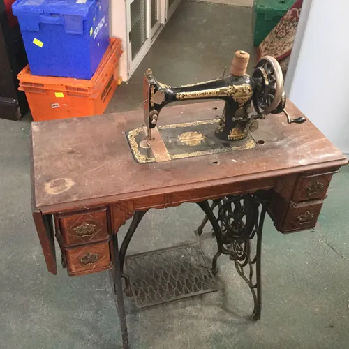 Vintage singer sewing machine with singer treadle cast iron table