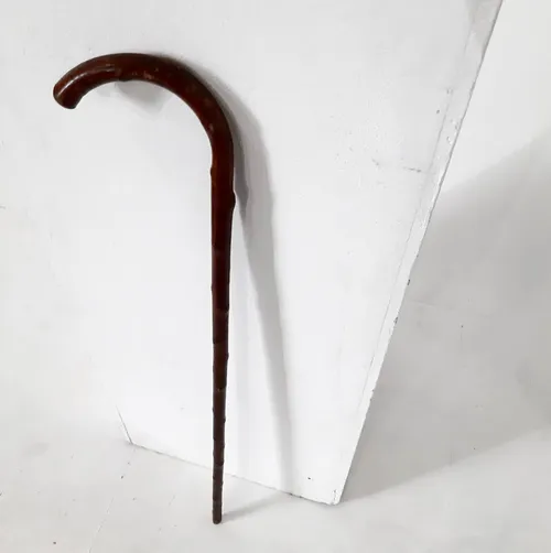 Brown walking stick with wood knots