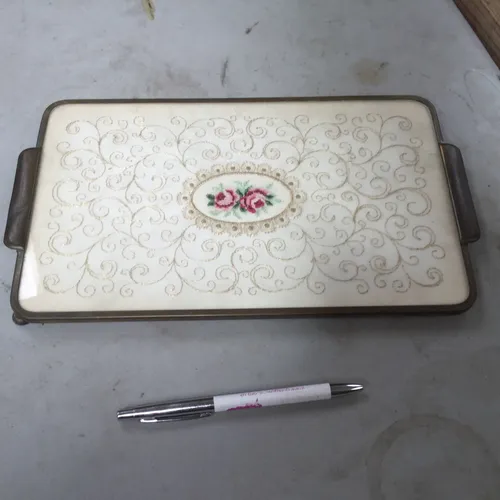 Rectangular mirror with thread and rose design on the back
