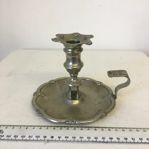 Silver chamberstick with flower shaped top