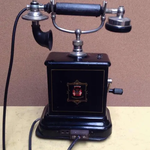 black and brass Jydsk cradle telephone with crank handle and flex cord