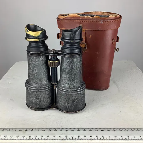 Black binoculars with brown leather case