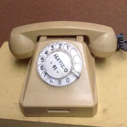 beige corded rotary dial telephone
