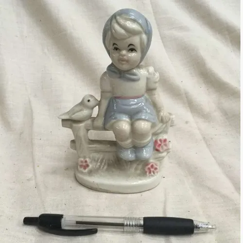 Blue and White Child Sitting in Garden Ornament