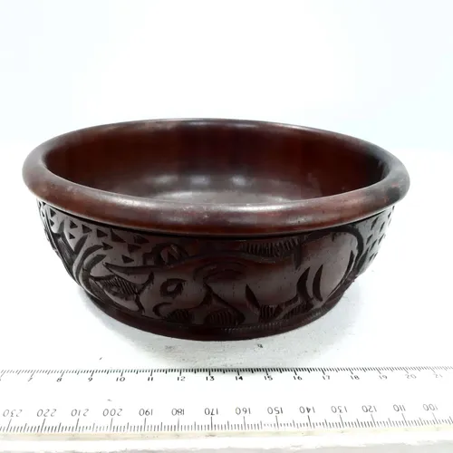 Wooden bowl with carved animal design