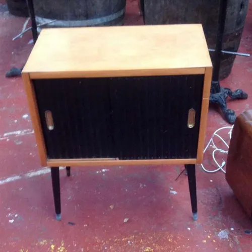 Mid century side table cabinet unit with sliding doors and danseuse legs.