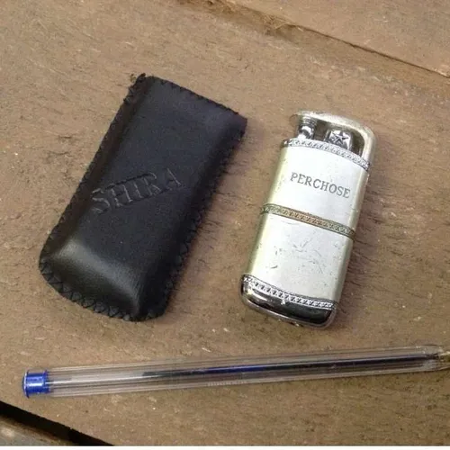 silver lighter with leather case