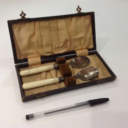 set of 2 tarnished spoons with cream handles in card case
