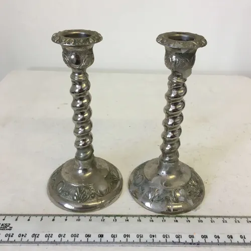 Pair of silver metal twisted candlesticks with engraved design