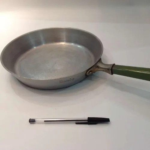 frying pan with green handle