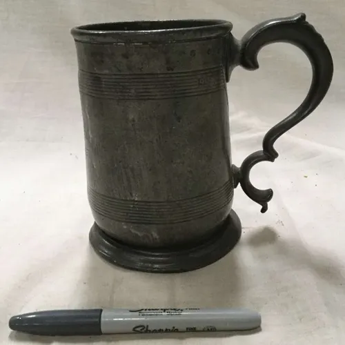 Dark metal tankard with engraved line details