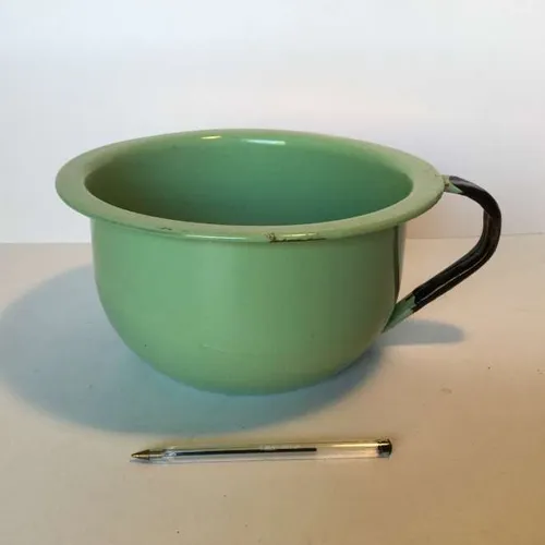 pale green enamelware mixing bowl with black handle