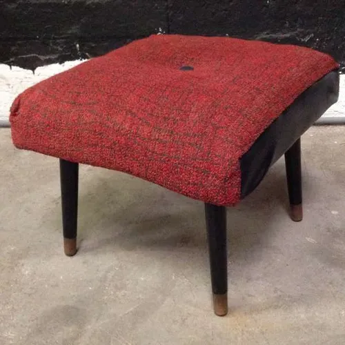 foot stool with red fabric cushion and black leather trim