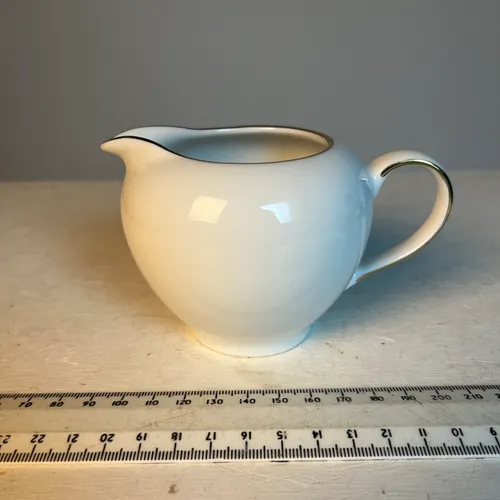 White and gold cream jug