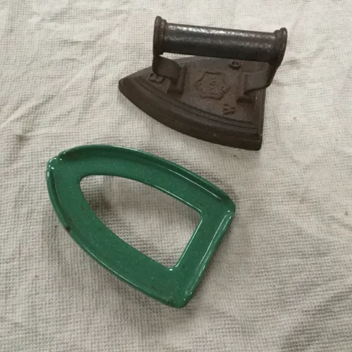 Metal iron with green stand